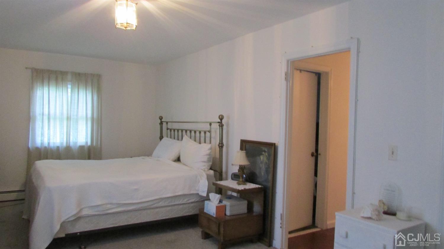 19 Hillsdale Road Edison, NJ 08820 - Photo 13 of 13 a bedroom with a bed and a chandelier