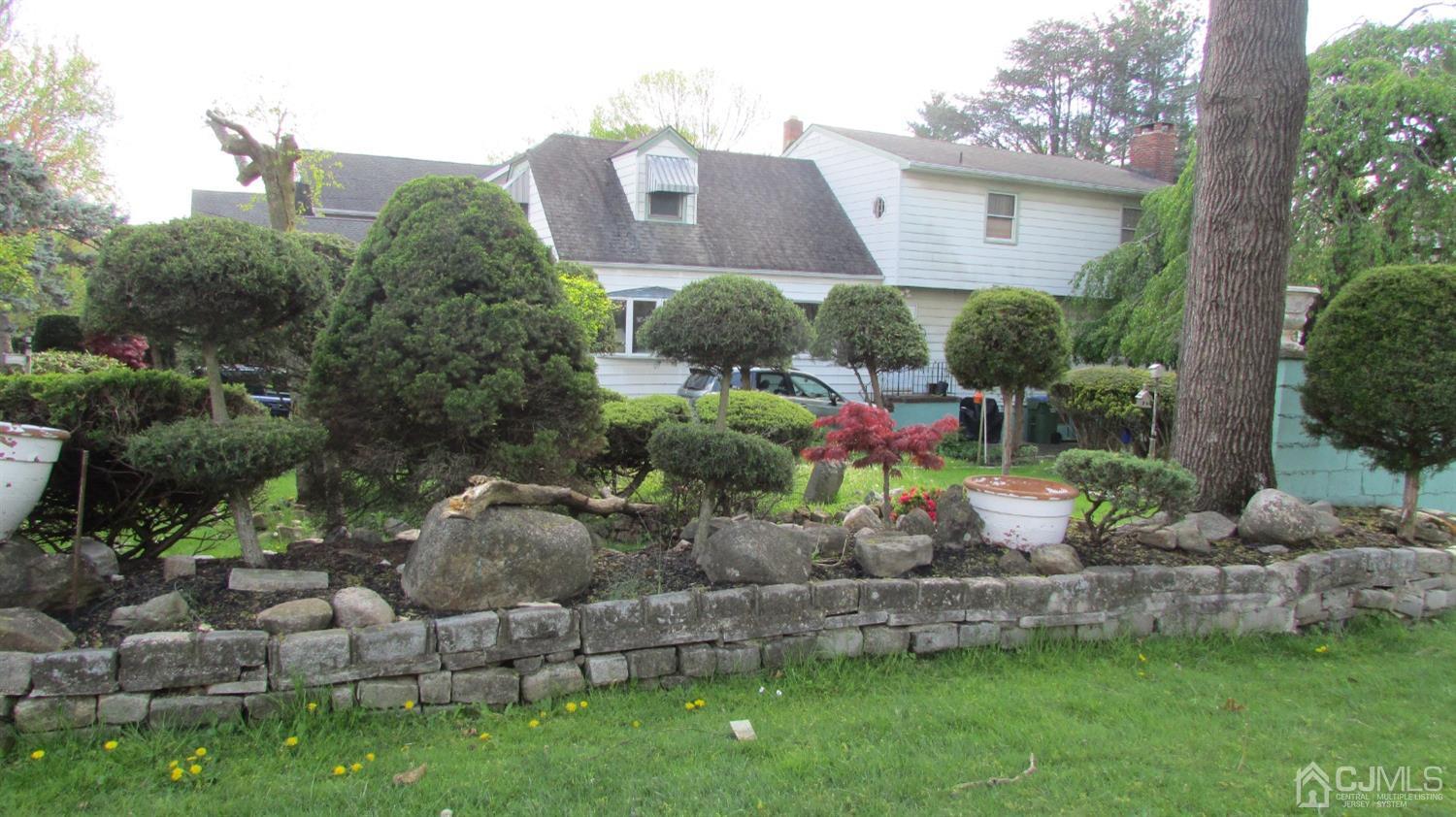 19 Hillsdale Road Edison, NJ 08820 - Photo 4 of 13 a view of a wooden house with a yard and plants