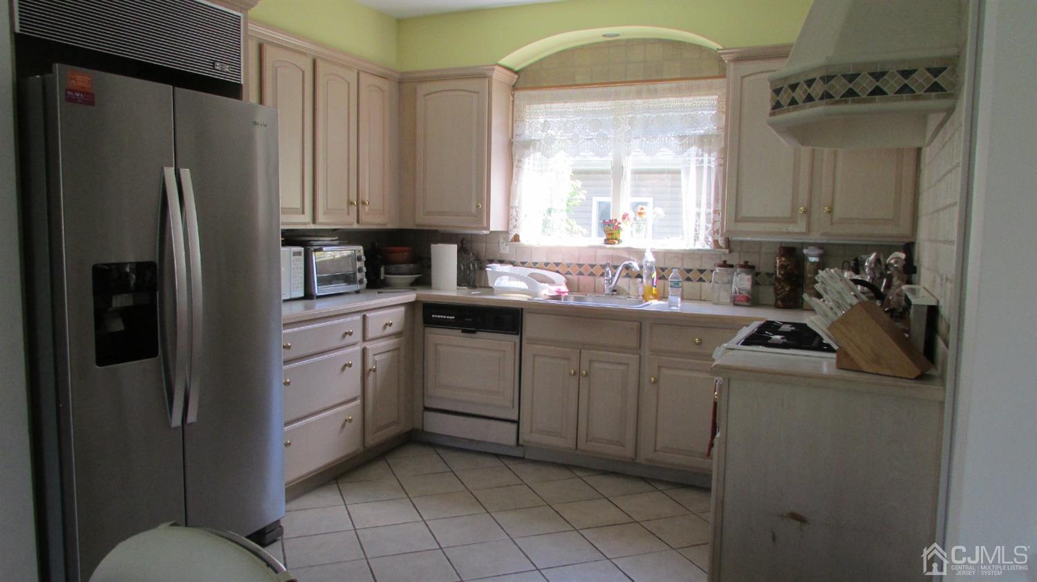 19 Hillsdale Road Edison, NJ 08820 - Photo 9 of 13 a kitchen with a refrigerator sink and cabinets