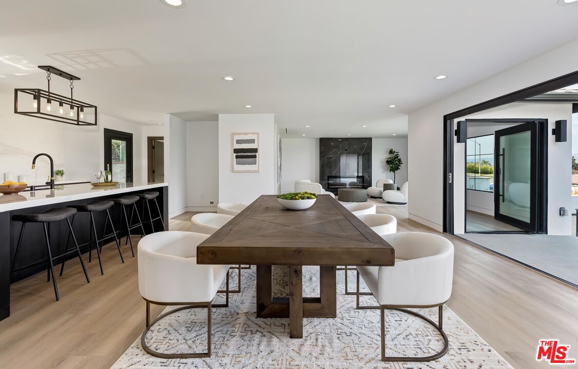 5236 Sanchez Drive Los Angeles, CA 90008 - Photo 11 of 32 a dining room with furniture a rug and a chandelier
