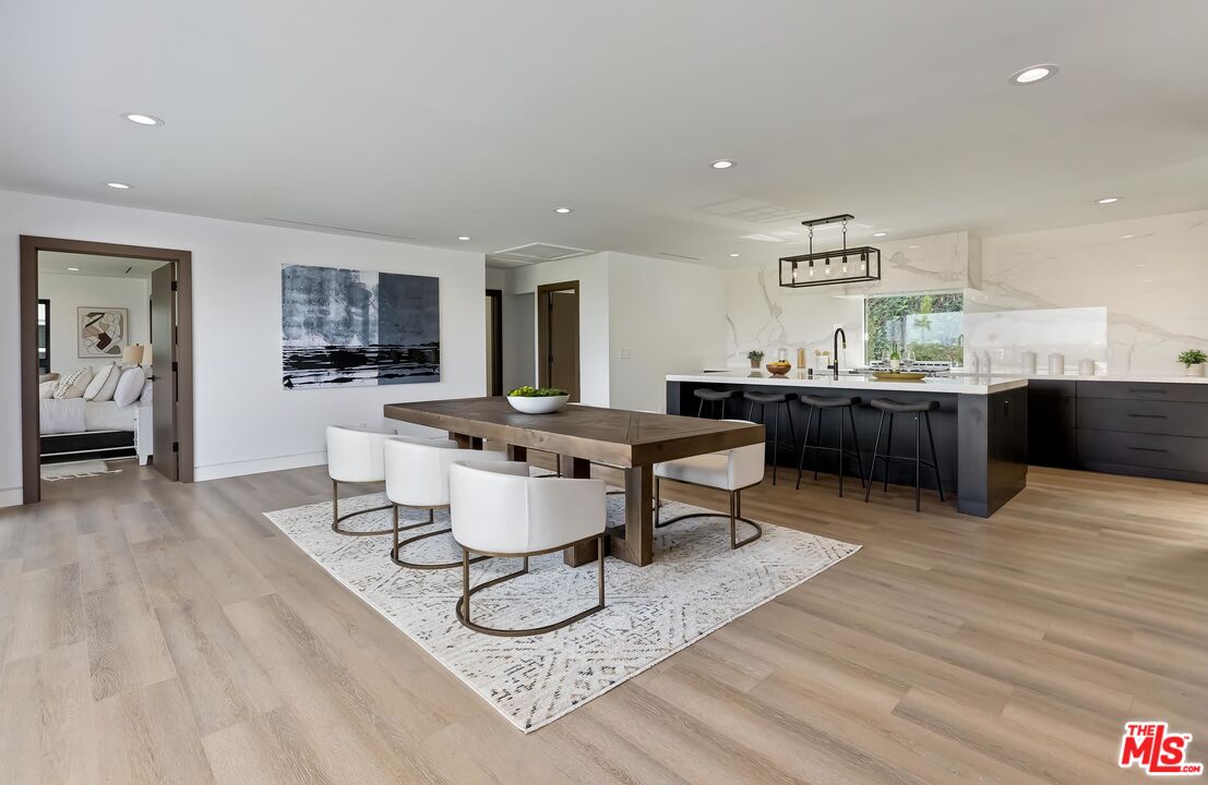 5236 Sanchez Drive Los Angeles, CA 90008 - Photo 13 of 32 a living room with furniture a large window and wooden floor