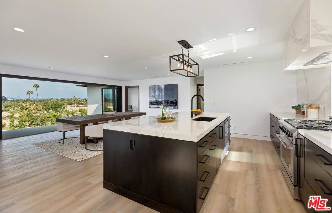 5236 Sanchez Drive Los Angeles, CA 90008 - Photo 16 of 32 a kitchen with stainless steel appliances granite countertop a sink stove and wooden floor