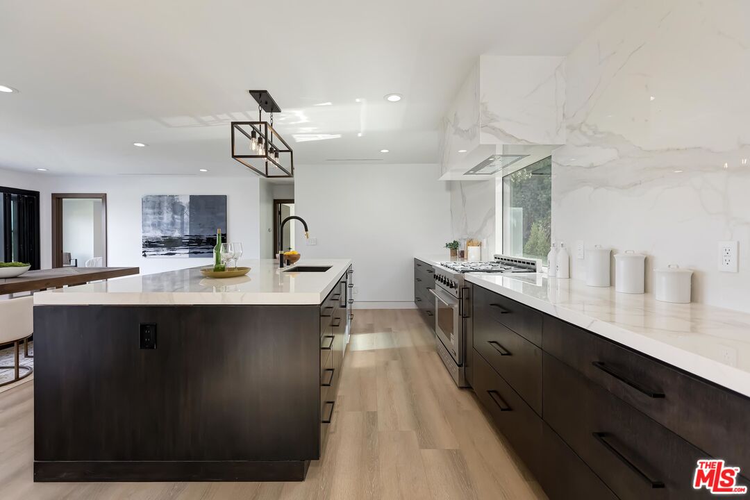 5236 Sanchez Drive Los Angeles, CA 90008 - Photo 17 of 32 a large kitchen with kitchen island a sink stainless steel appliances and cabinets