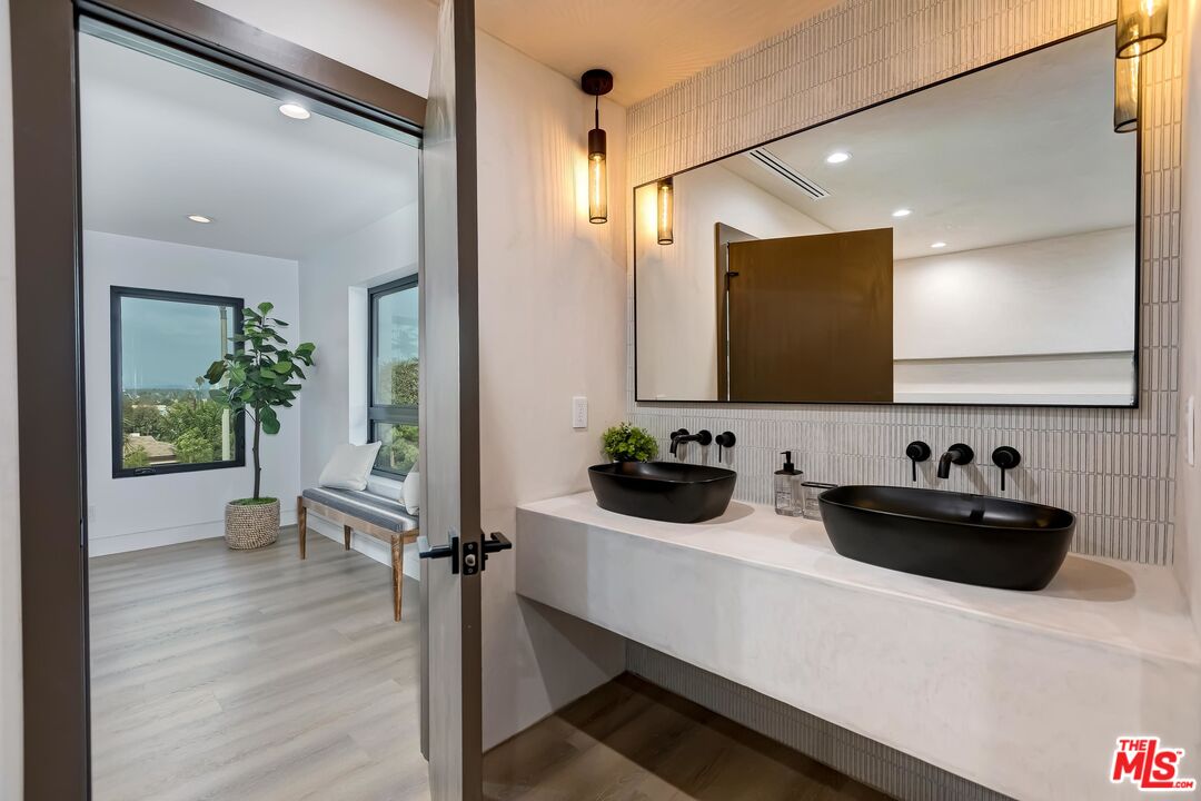 5236 Sanchez Drive Los Angeles, CA 90008 - Photo 21 of 32 a bathroom with a sink a mirror and a shower