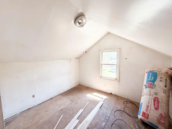 a view of a hardwood floor and staircase