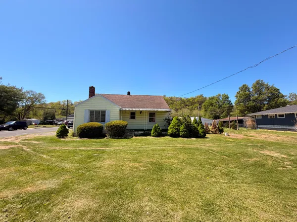 a view of a house with pool and a yard