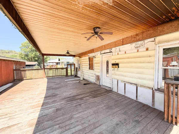 a view of a porch with wooden floor