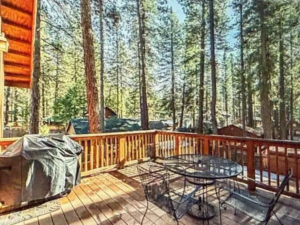 a view of balcony with wooden floor and outdoor seating