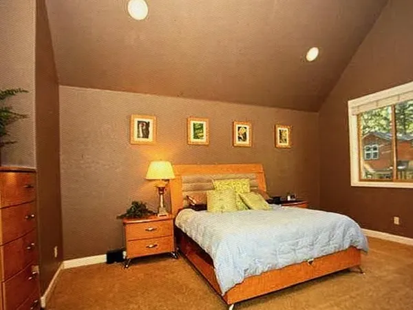 a bedroom with a bed and window