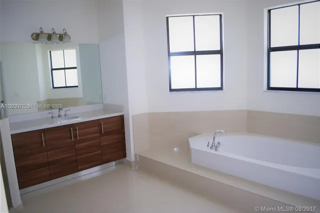 a view of a small space with wooden floor and sliding door