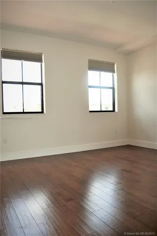 a view of a yard with plants and trees