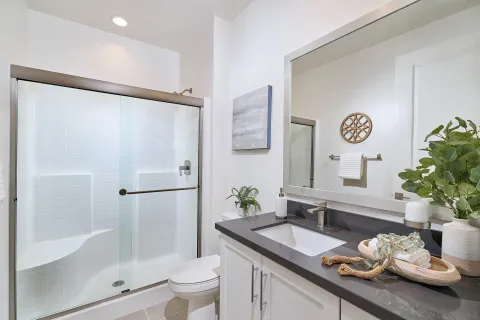 a kitchen with granite countertop white cabinets and a stove