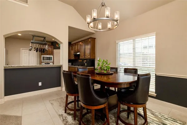 a view of a dining room with furniture and chandelier