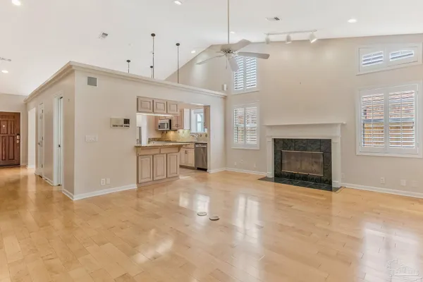 a large kitchen with cabinets and a fireplace