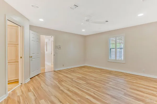 a view of a room with walk in closet and wooden floor