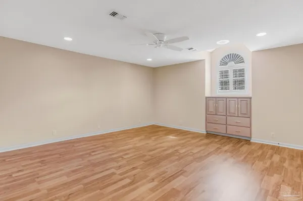 a view of an empty room with wooden floor