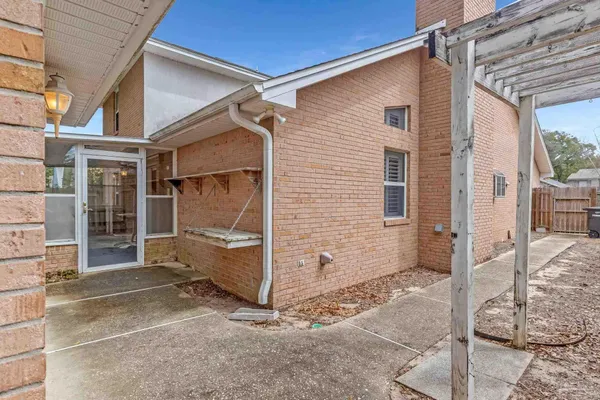 a view of a porch with a floor to ceiling window next to a yard