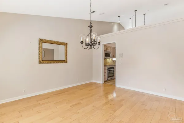 a view of a room with a stylish ceiling fan and entryway