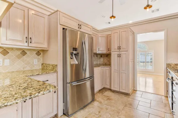 a kitchen with stainless steel appliances granite countertop a refrigerator and a sink