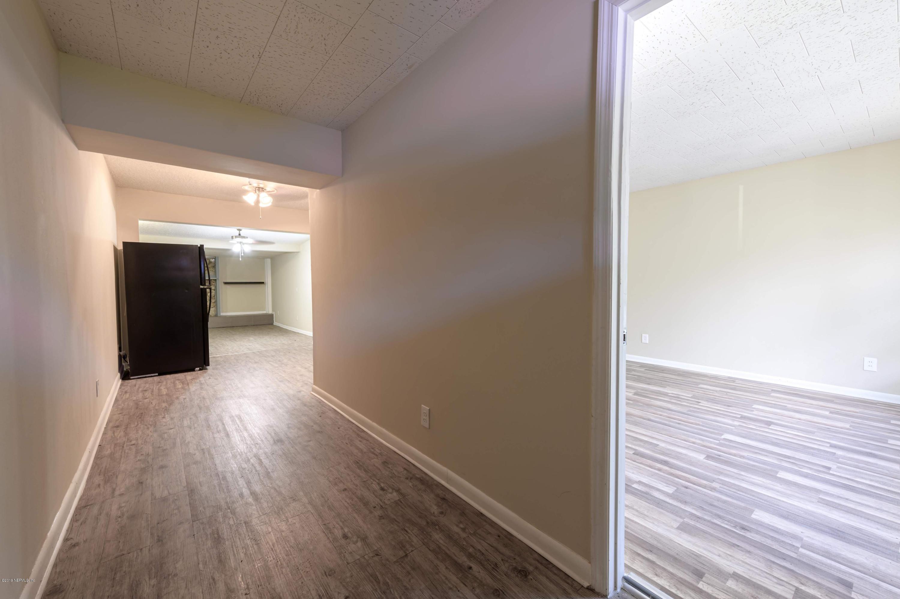 6931 Clovis Road Jacksonville, FL 32205 - Photo 8 of 34 a view of a hallway with wooden floor