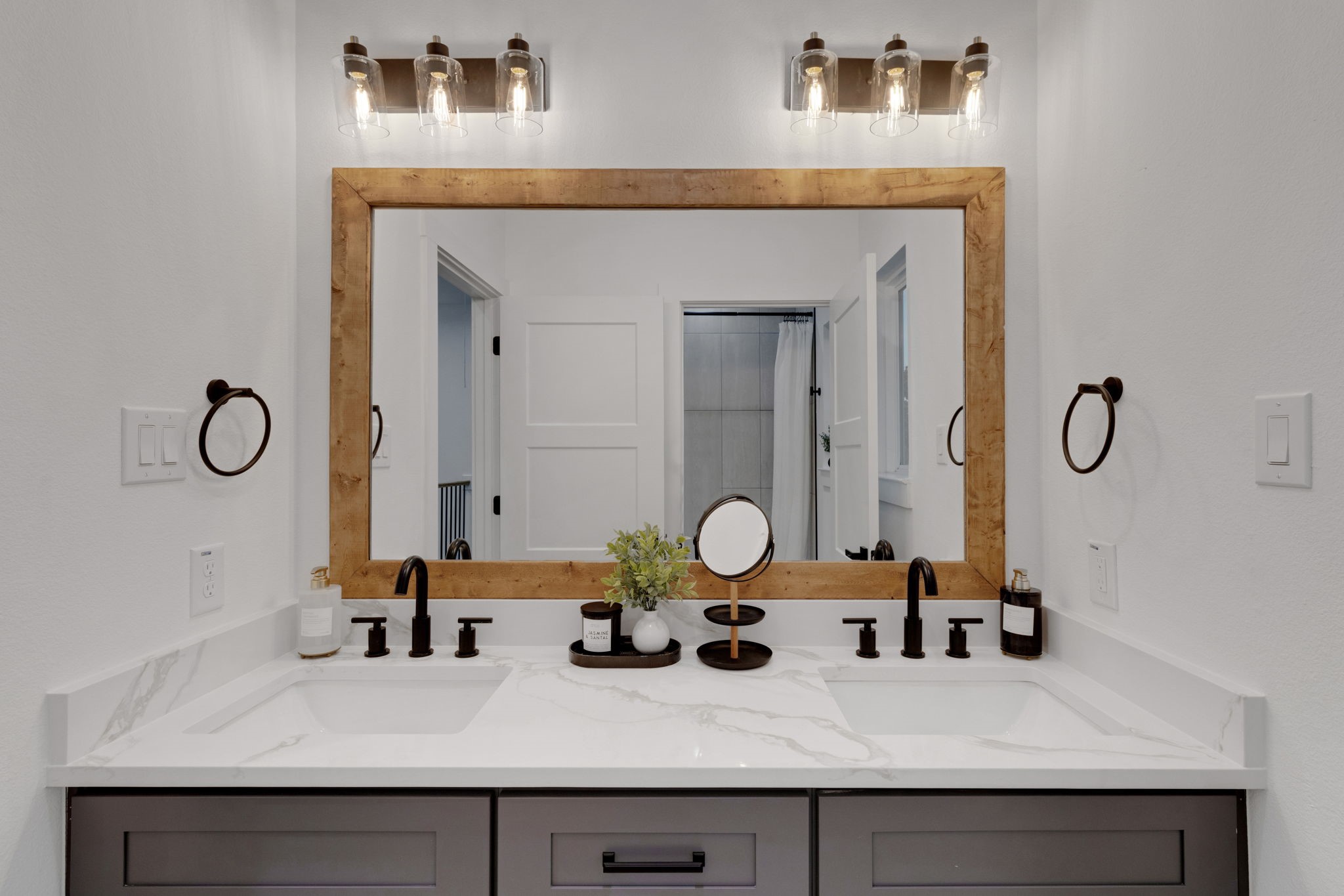 4202 Plaag Street Houston, TX 77016 - Photo 30 of 38 Secondary bath with dual sinks, quartz counters, and matte black fixtures for a sleek, modern look.