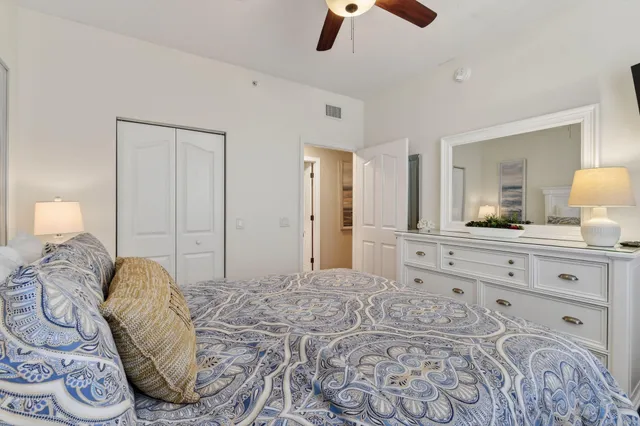 a bedroom with a large bed and a lamp