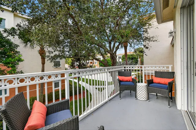 a view of a two chairs in the balcony