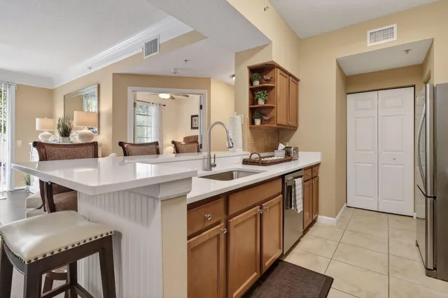 a kitchen with a sink cabinets and refrigerator