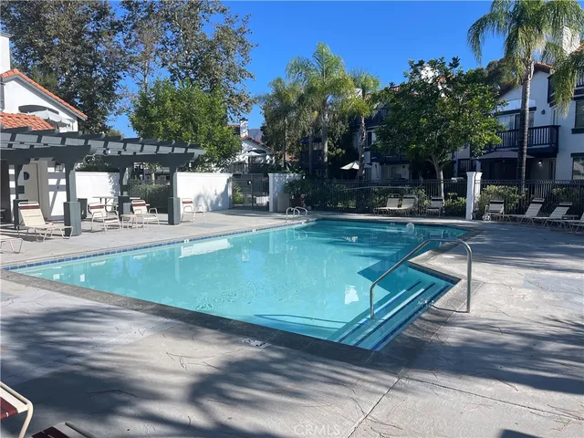 a view of a backyard with swimming pool