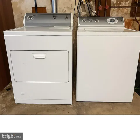 a view of a house with a wooden fence