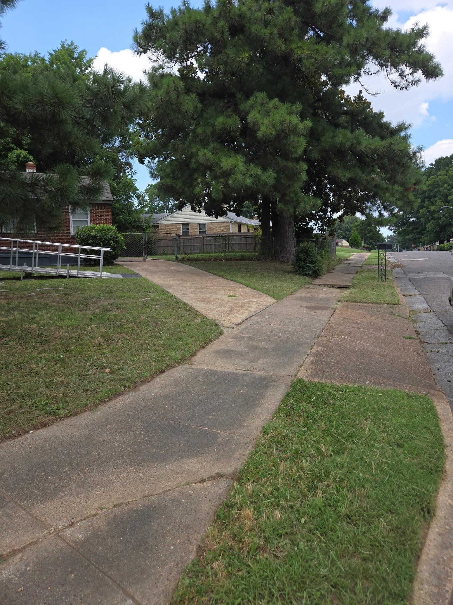 1510 Gausco Road Memphis, TN 38106 - Photo 10 of 10 Concrete driveway extending to a brick-clad residence