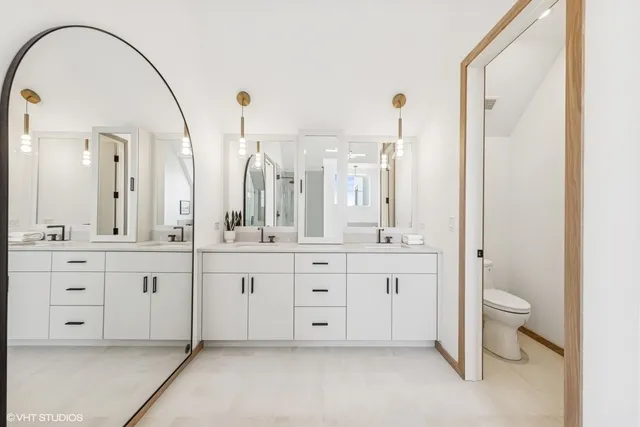 a spacious bathroom with a granite countertop sink mirror and toilet
