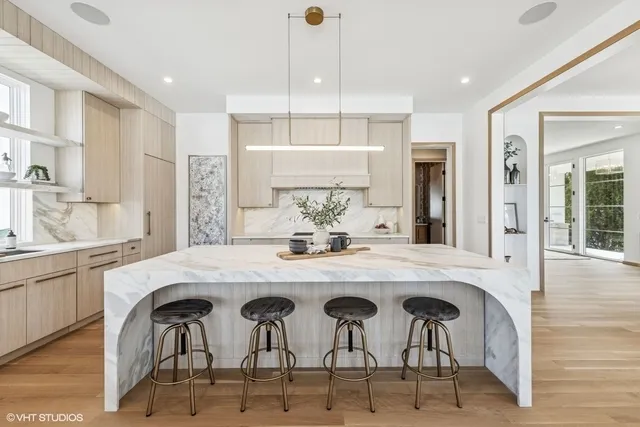 a large kitchen with a table and chairs