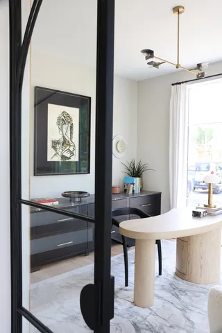 a living room with furniture and a potted plant