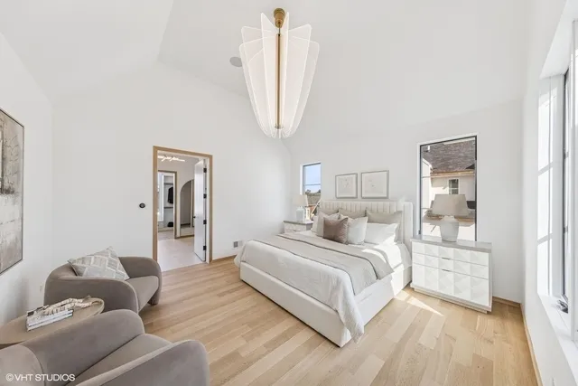 a bedroom with a bed couches and table