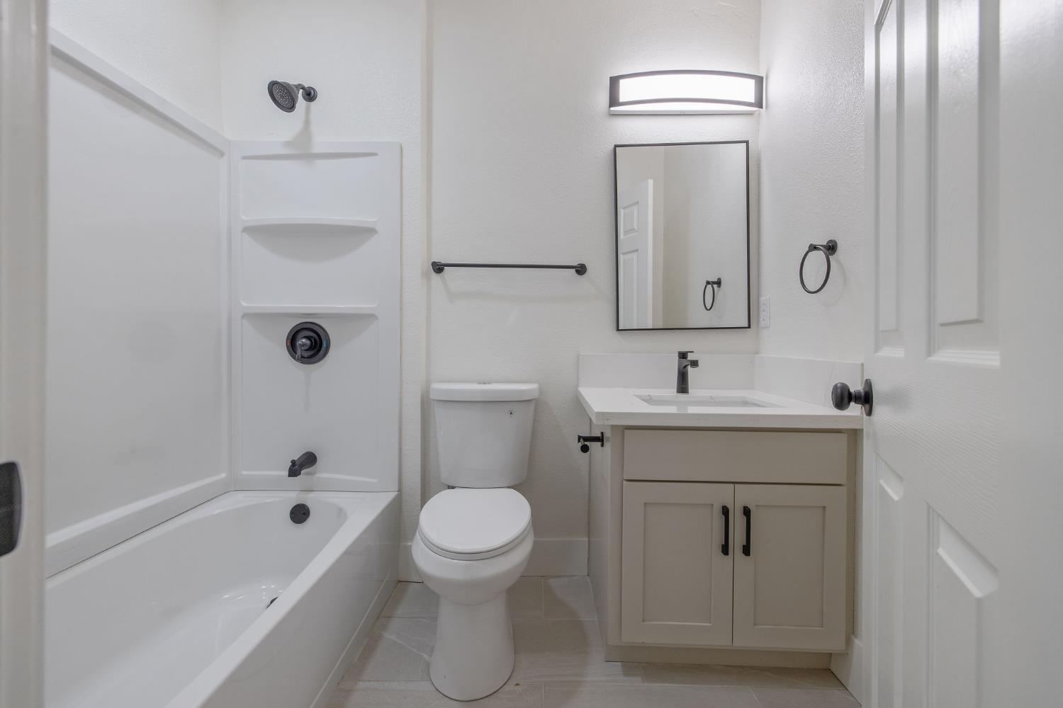 1402 Middleton Street Hanford, CA 93230 - Photo 12 of 40 a bathroom with a sink toilet and shower