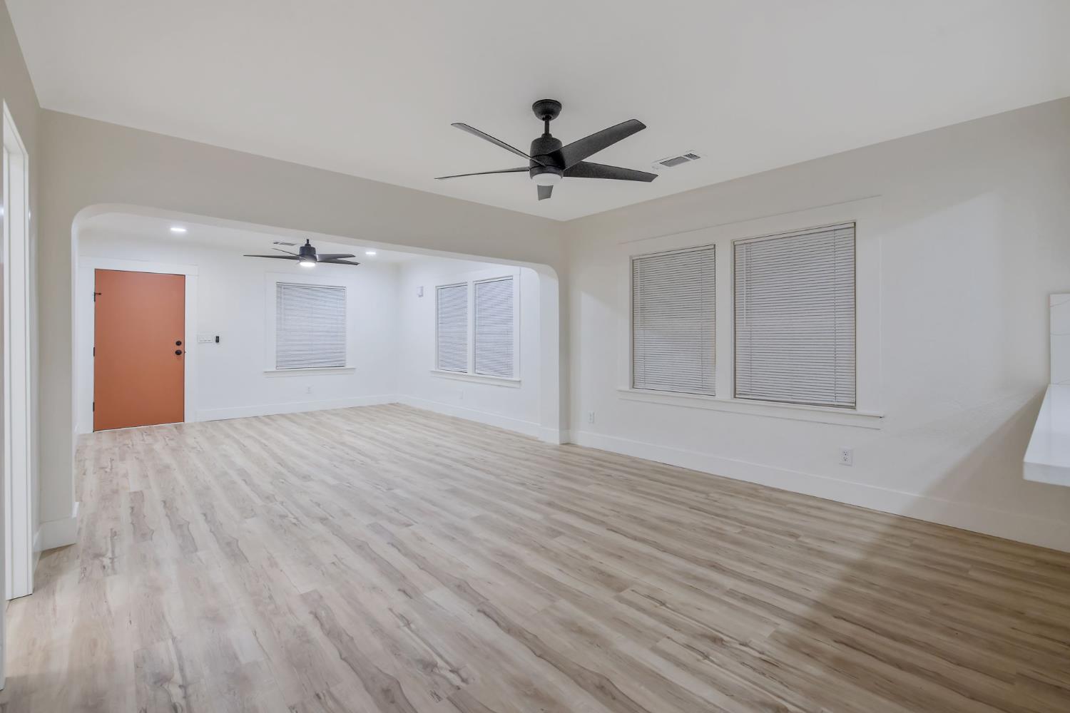1402 Middleton Street Hanford, CA 93230 - Photo 13 of 40 a view of an empty room with wooden floor and a ceiling fan
