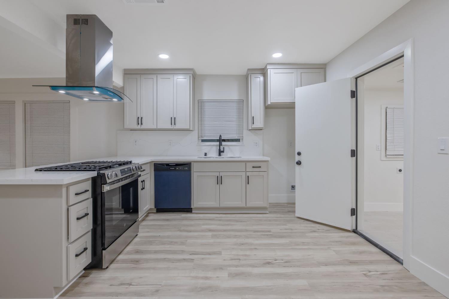 1402 Middleton Street Hanford, CA 93230 - Photo 21 of 40 a kitchen with stainless steel appliances granite countertop a stove a sink and a refrigerator