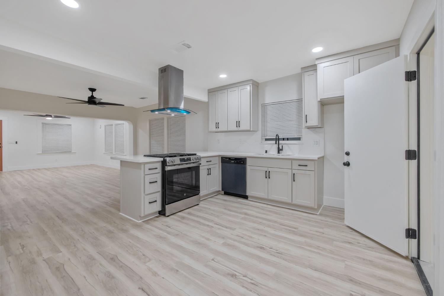 1402 Middleton Street Hanford, CA 93230 - Photo 22 of 40 a kitchen with a sink cabinets stainless steel appliances and a window