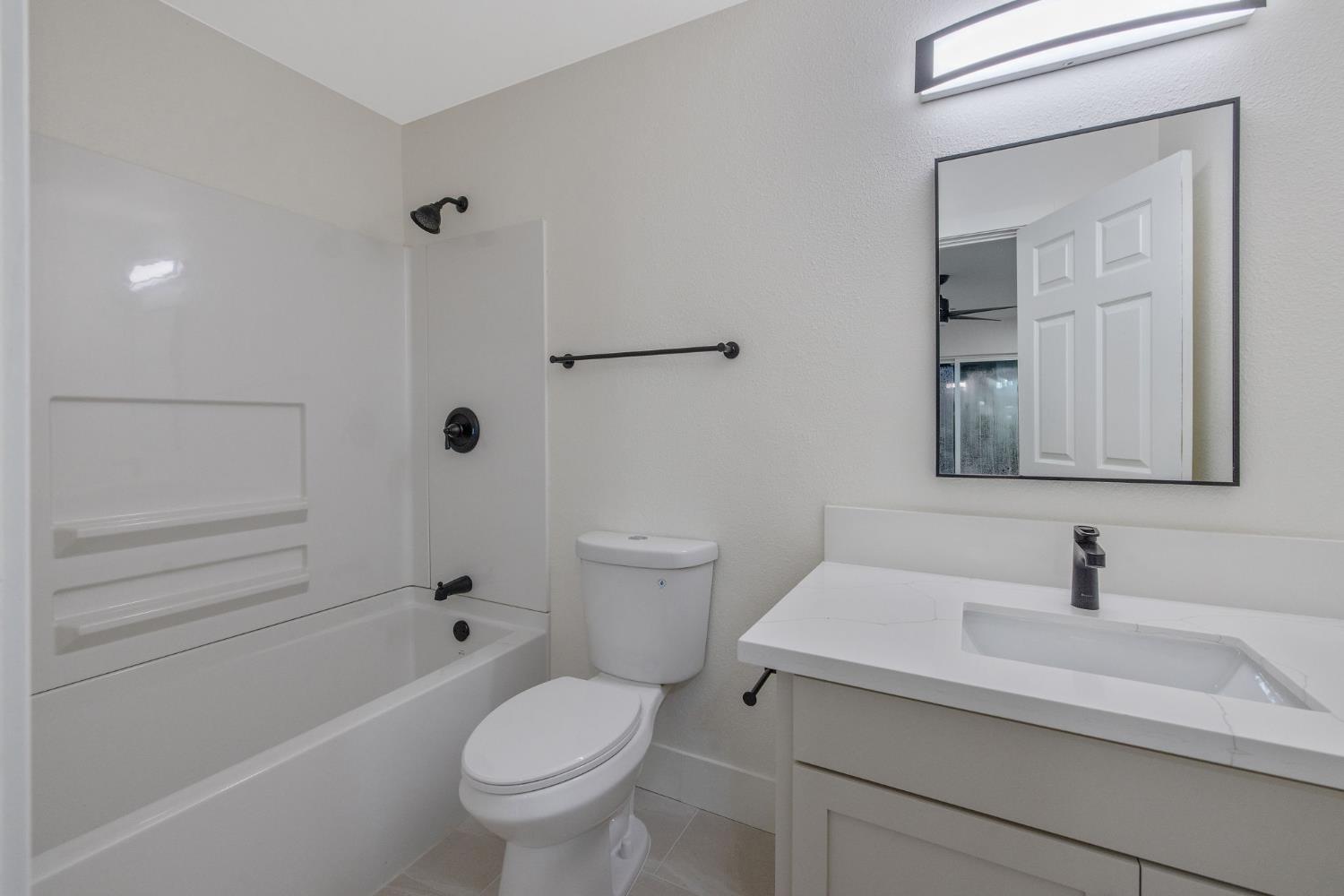 1402 Middleton Street Hanford, CA 93230 - Photo 29 of 40 a bathroom with a sink a toilet and shower