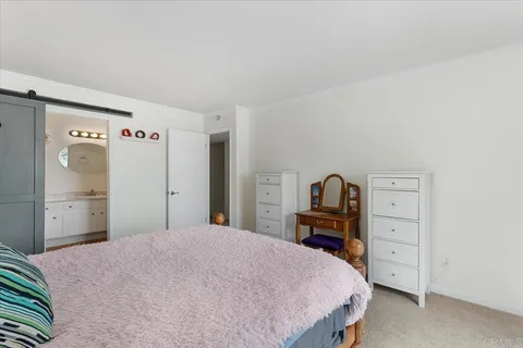 a bathroom with a granite countertop sink a mirror and shower