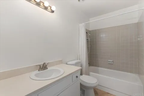 a living room with furniture and a ceiling fan