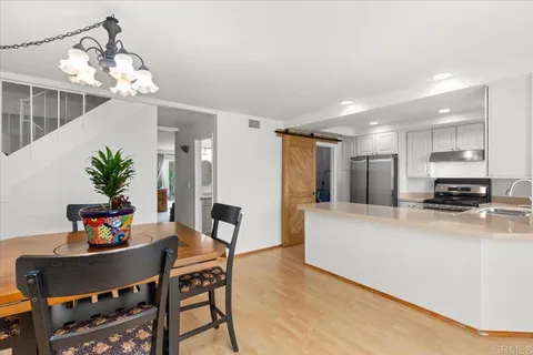 a view of a dining room with furniture and a potted plant