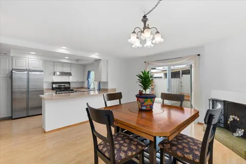 a kitchen with a dining table and chairs