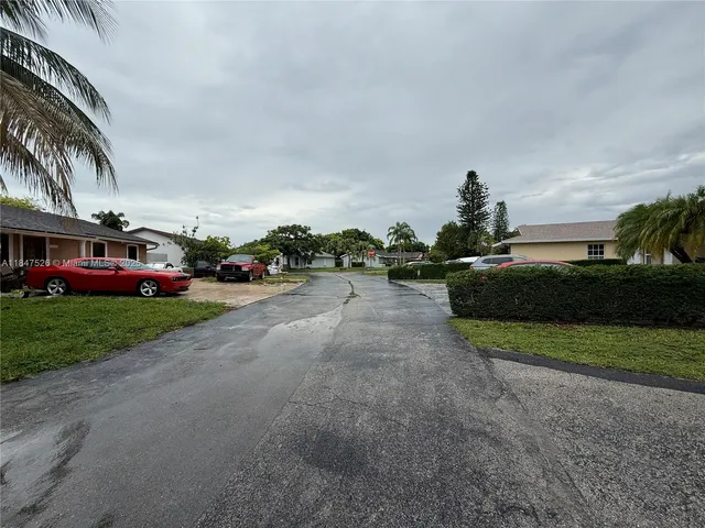 a view of a street with cars parked