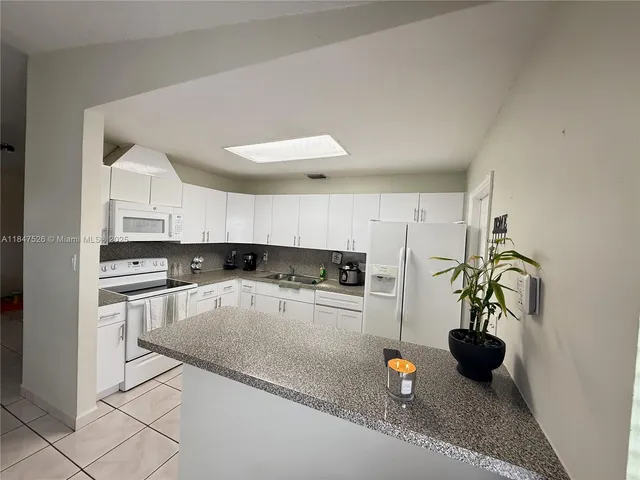 a kitchen with stainless steel appliances granite countertop a sink and a stove