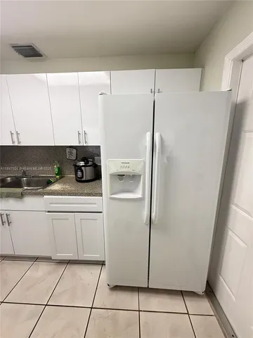 a white refrigerator freezer sitting inside of a kitchen