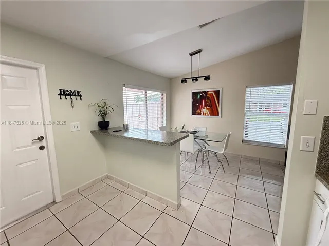 a view of kitchen with furniture and window