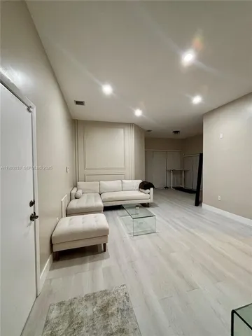 a bedroom with a bed and a wall painting