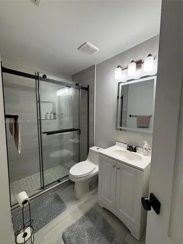 a bathroom with a sink toilet and shower